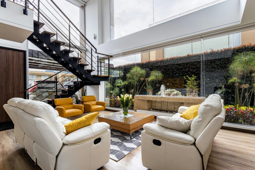 Bright, modern living room in Cajicá with glass walls and garden view.