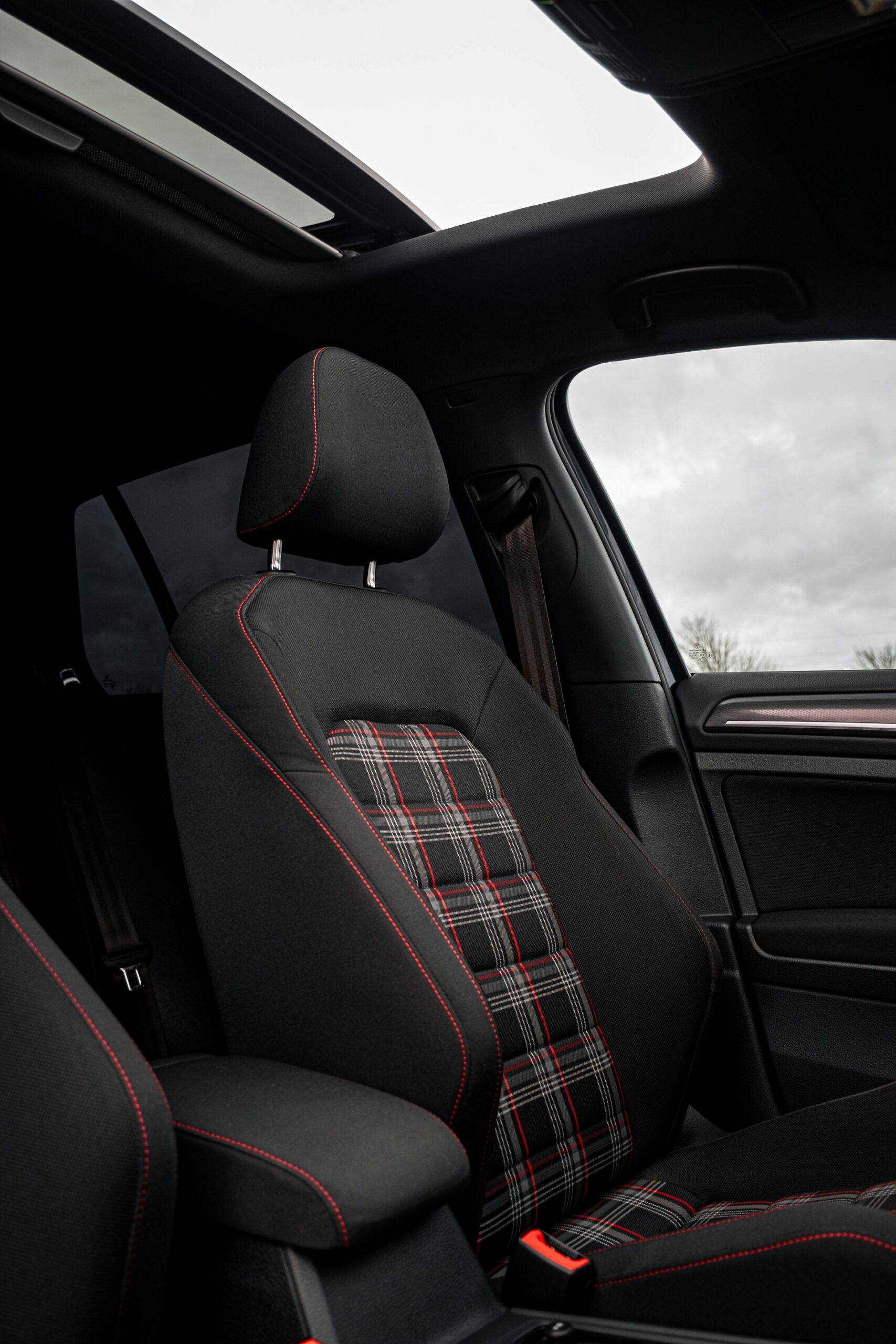 Interior of a modern car with a sunroof and plaid seat design in Totes, Normandie, France.
