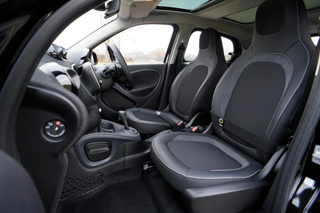 Explore the sleek interior of a modern luxury car featuring leather seats and advanced technology.