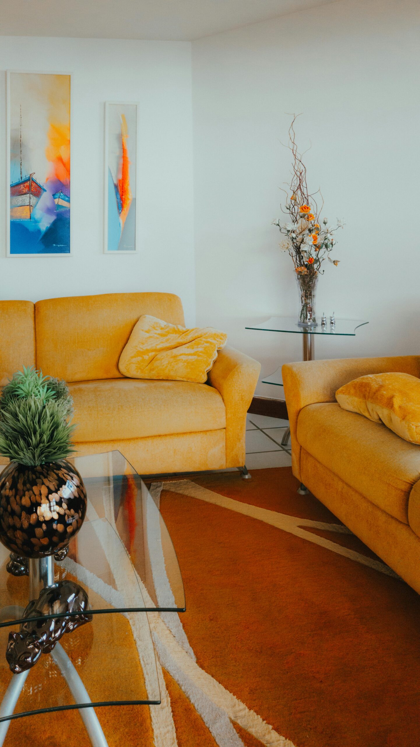 Bright and cozy living room featuring yellow sofas, abstract art, and stylish decor for a modern home.